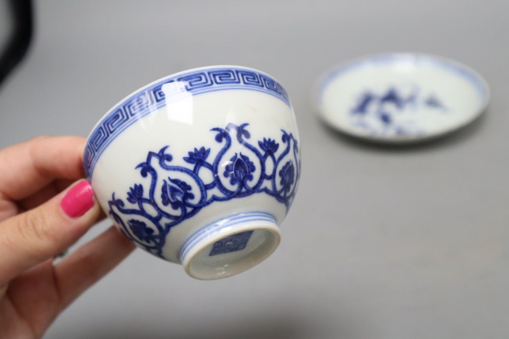 Two Chinese blue and white cups and a saucer, one with reign mark